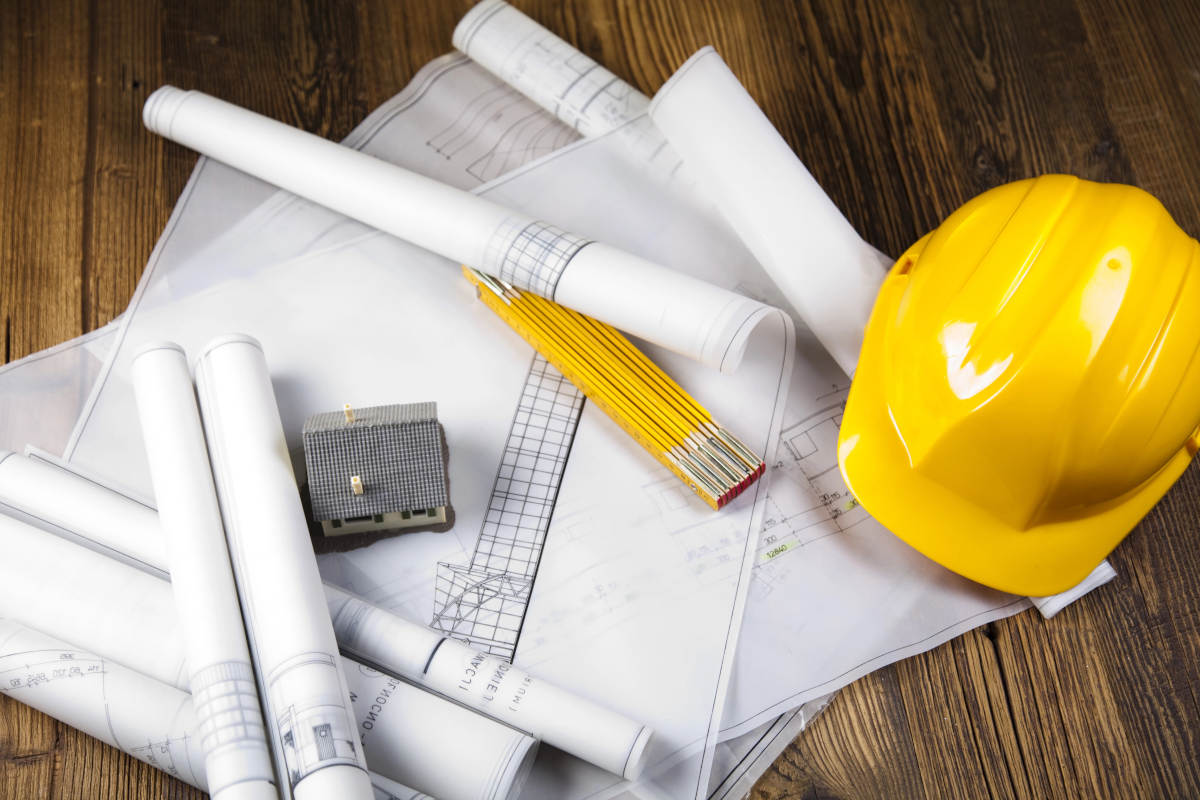 Blueprints with ruler and hard hat